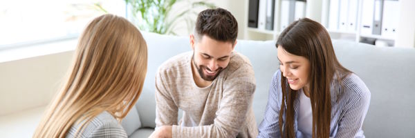 Zer egin behar dut hombre-mujer-sonriendo con otra mujer en frente