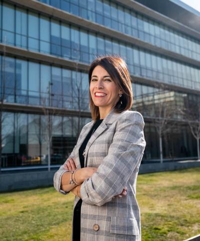 Mujer de negocios sonriendo frente a edificio de oficinas - Rural Kutxa